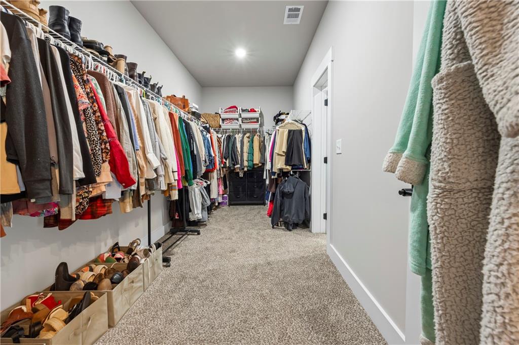 152 White Oak Way Monroe, GA 30655 - Photo 22 of 65 a view of walk in closet with clothes
