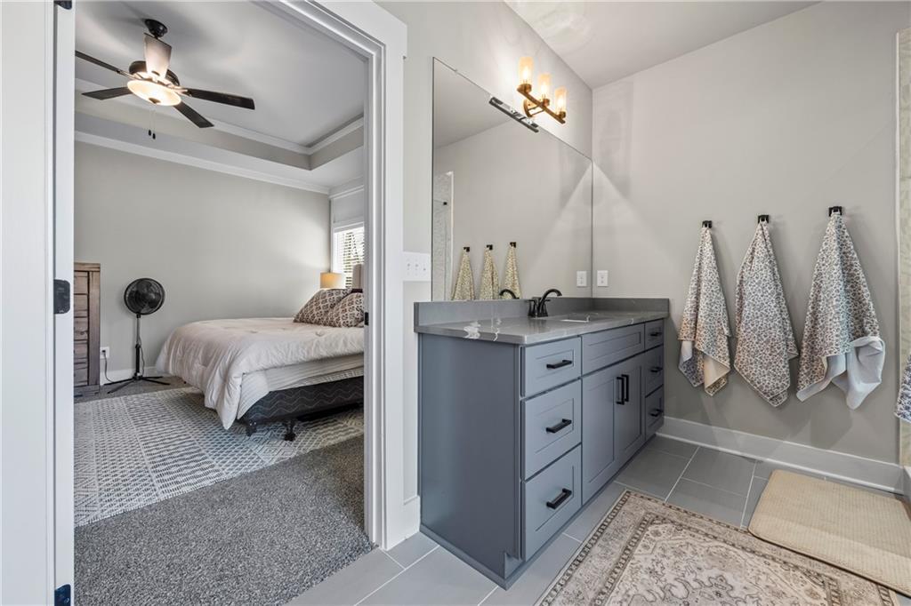 152 White Oak Way Monroe, GA 30655 - Photo 24 of 65 a bedroom with a bed and a chandelier