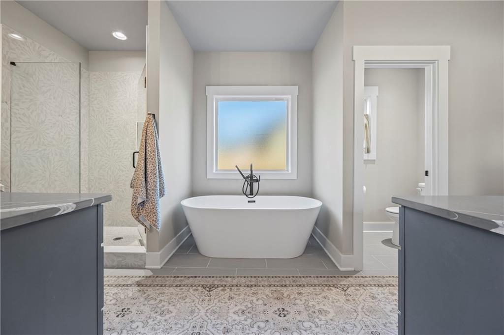 152 White Oak Way Monroe, GA 30655 - Photo 26 of 65 a bath room with a sink and a mirror
