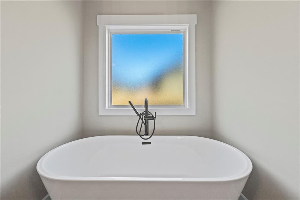 152 White Oak Way Monroe, GA 30655 - Photo 27 of 65 a white bath tub sitting in a bathroom