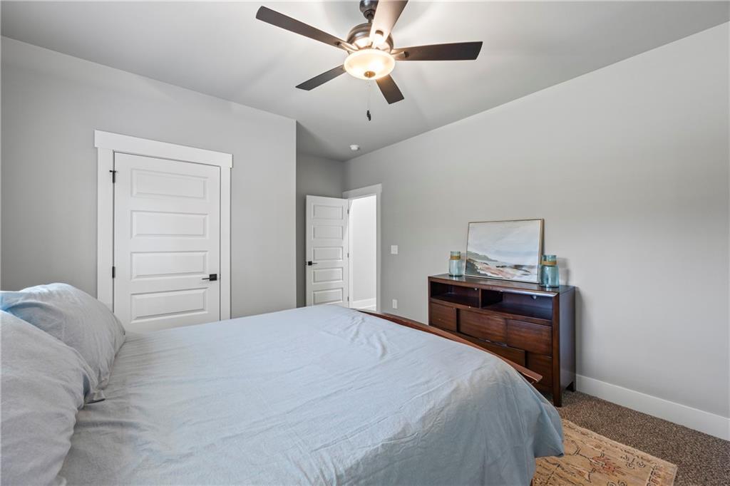 152 White Oak Way Monroe, GA 30655 - Photo 30 of 65 a bedroom with a bed and a chandelier