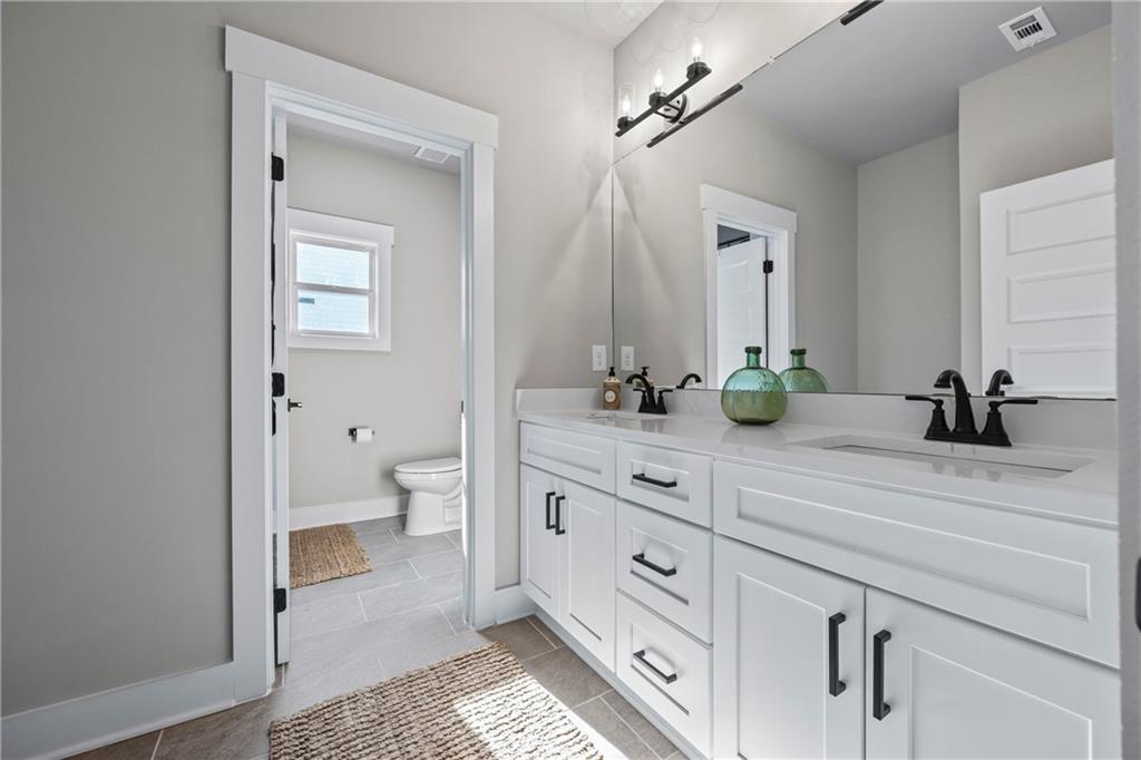 152 White Oak Way Monroe, GA 30655 - Photo 31 of 65 a spacious bathroom with a granite countertop toilet sink and mirror