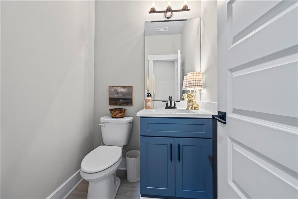 152 White Oak Way Monroe, GA 30655 - Photo 35 of 65 a bathroom with a toilet sink and mirror