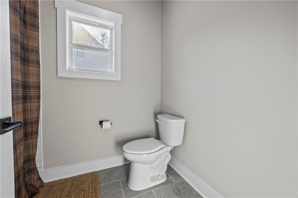 152 White Oak Way Monroe, GA 30655 - Photo 38 of 65 a white toilet sitting next to a bathroom sink