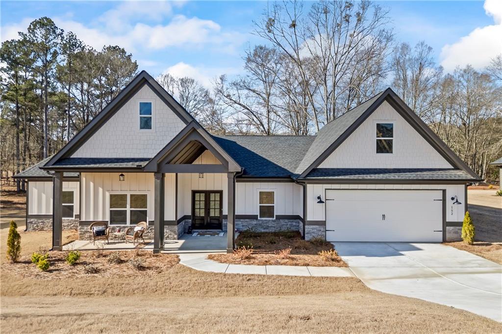 152 White Oak Way Monroe, GA 30655 - Photo 48 of 65 a front view of a house with a yard covered in snow