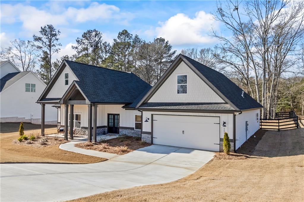 152 White Oak Way Monroe, GA 30655 - Photo 51 of 65 a front view of a house with a yard and garage