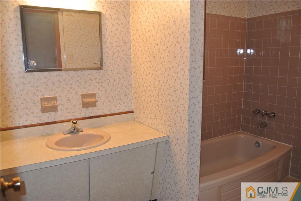 17 Woodruff Road Edison, NJ 08820 - Photo 14 of 25 a bathroom with a sink and a bathtub