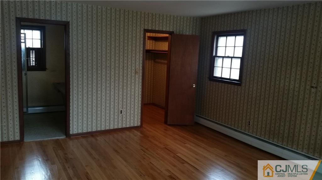 17 Woodruff Road Edison, NJ 08820 - Photo 16 of 25 an empty room with wooden floor and windows