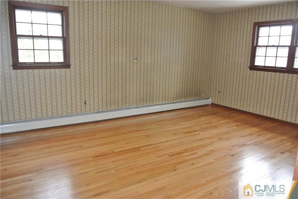 17 Woodruff Road Edison, NJ 08820 - Photo 18 of 25 an empty room with wooden floor and windows