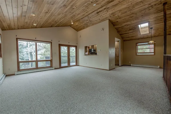 a view of an empty room with windows