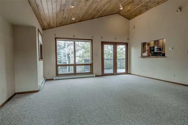 a view of a livingroom with an empty space and a window