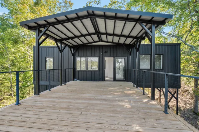a view of backyard with wooden floor and fence
