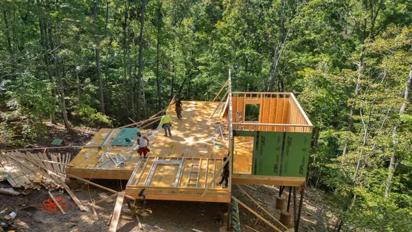 an aerial view of residential house with outdoor space and trees all around