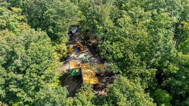 an aerial view of a house with a yard