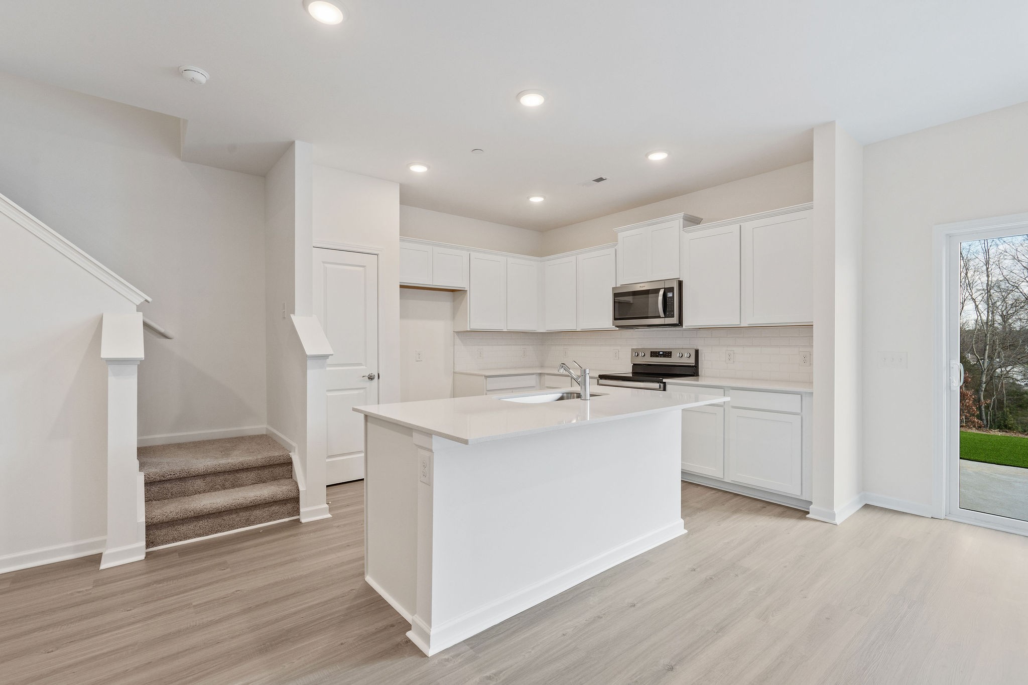 7124 Mapleside Lane Fairview, TN 37062 - Photo 12 of 30 a kitchen with white cabinets and white appliances