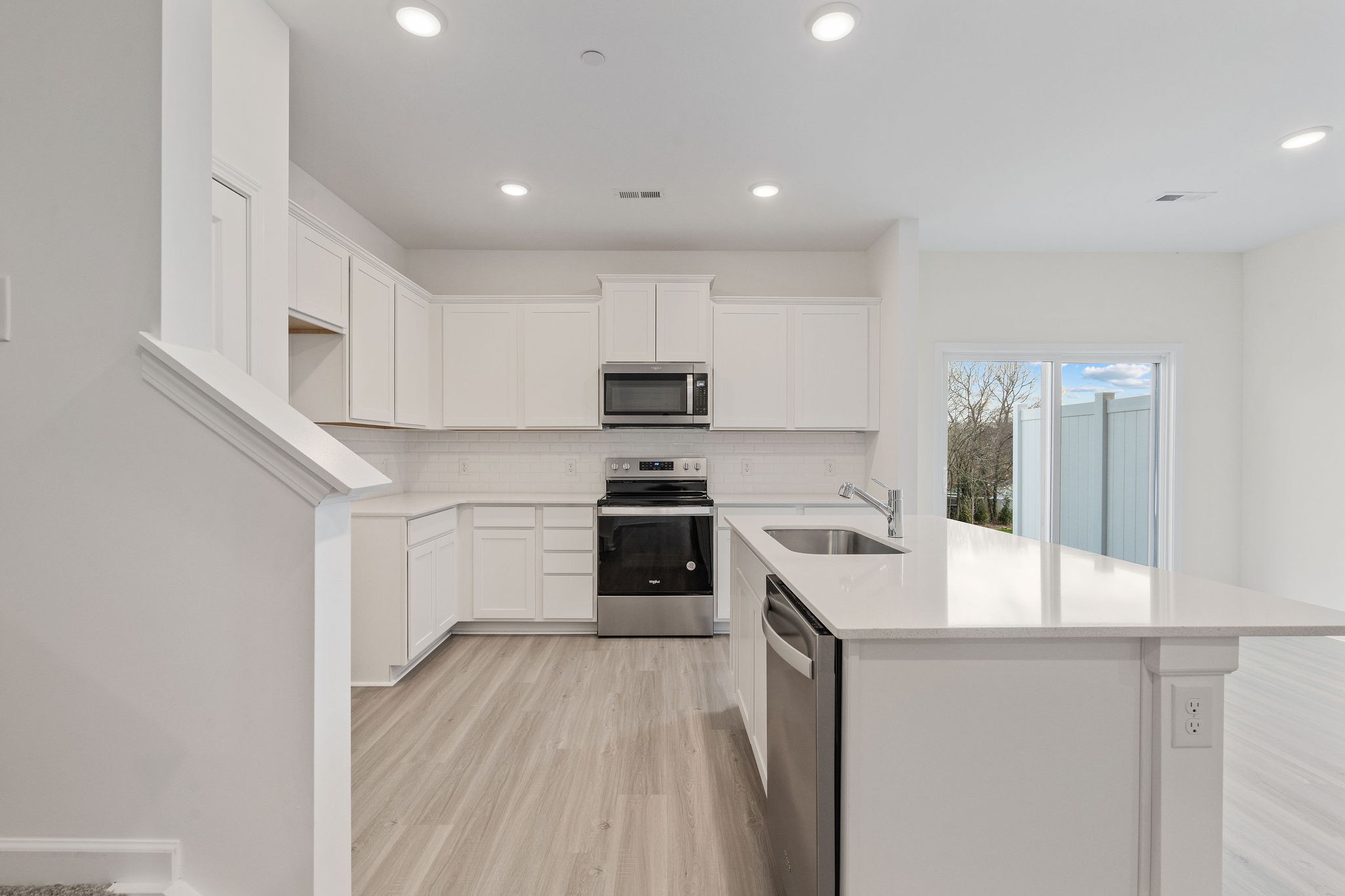 7124 Mapleside Lane Fairview, TN 37062 - Photo 6 of 30 a kitchen with white cabinets and stainless steel appliances