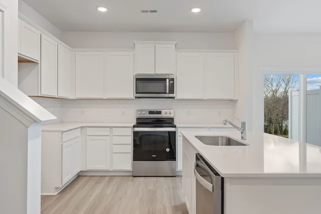 a kitchen with a sink cabinets and stainless steel appliances