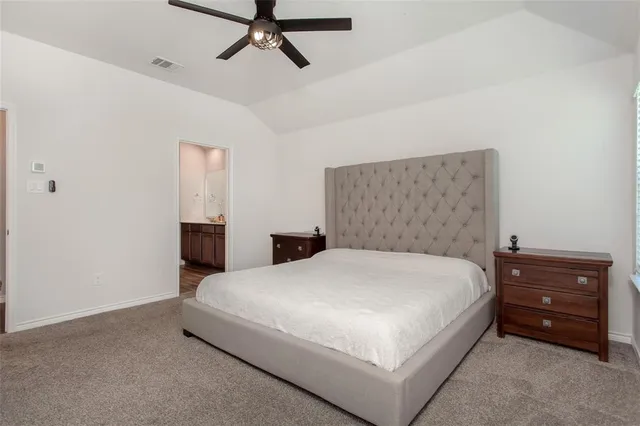 a bedroom with a bed and a dresser