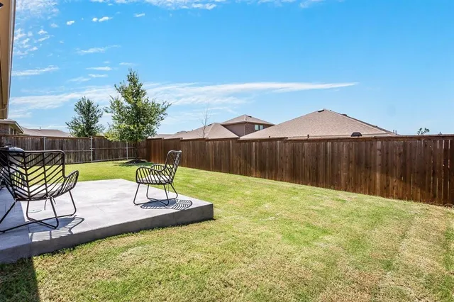 a view of a chair and table on the wooden floor