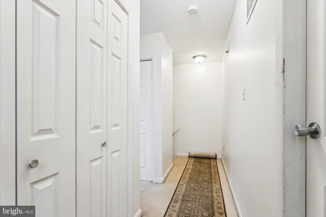 a bathroom with a toilet sink vanity and mirror