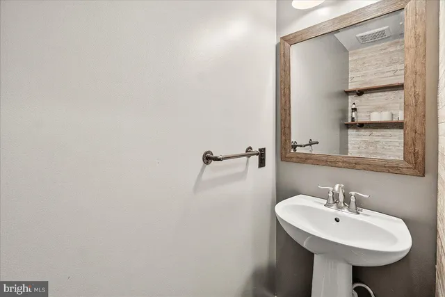 a bathroom with a sink a mirror and a toilet