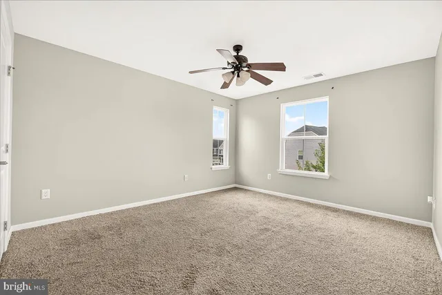 a view of room with a ceiling fan and window
