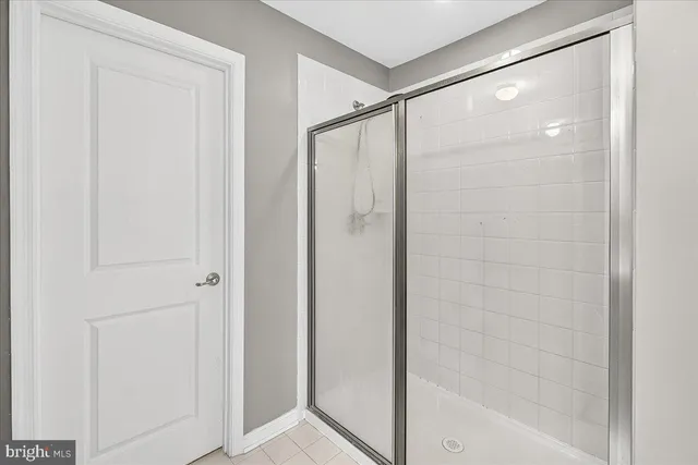 a bathroom with a glass shower door