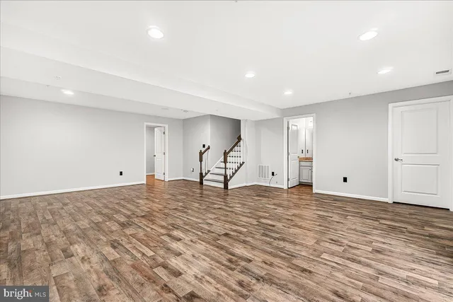 a view of a room with wooden floor