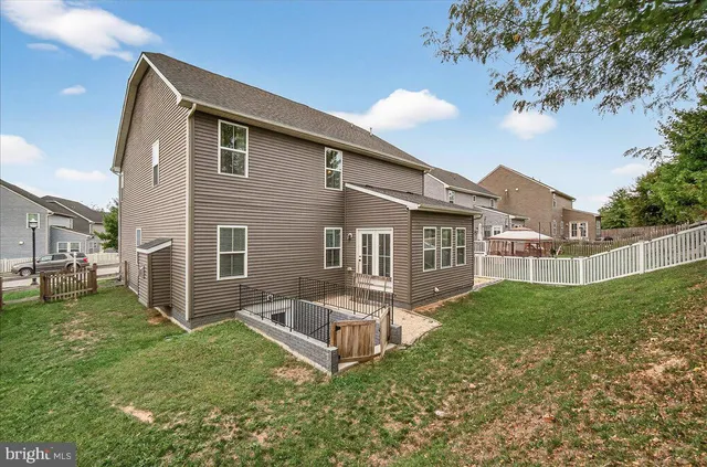 a backyard of a house with table and chairs