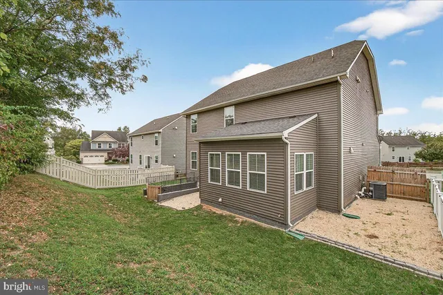 a view of a house with a yard and sitting area