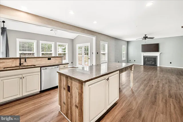 a kitchen with granite countertop a sink and cabinets