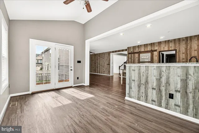 a view of a big room with wooden floor and windows