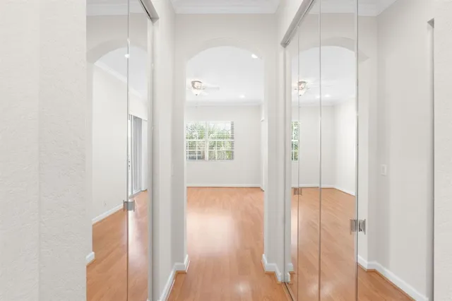 an empty room with wooden floor and mirror