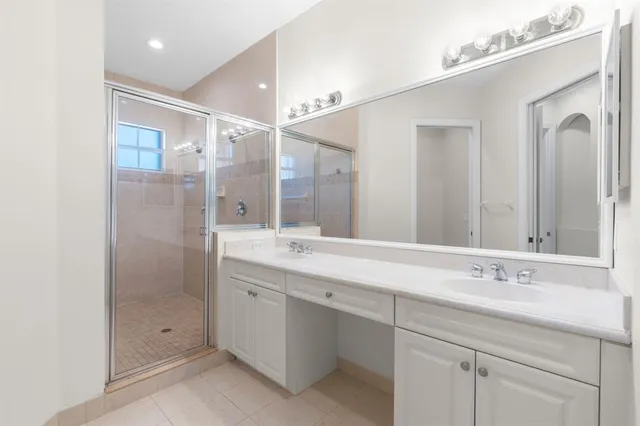 a bathroom with a shower sink and mirror