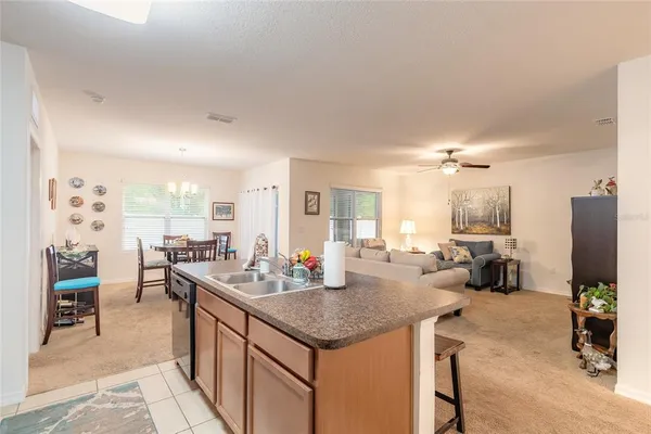 a kitchen with a counter top space and living room