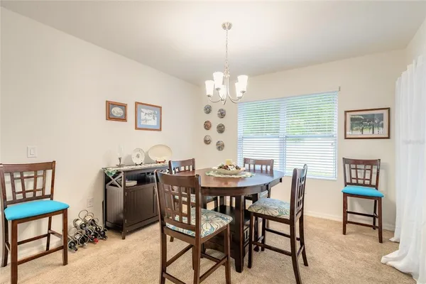 a view of a dining room with furniture and chandelier
