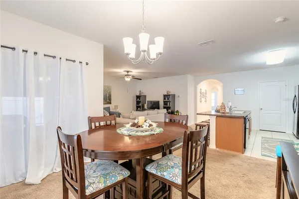 a view of a dining room with furniture and window