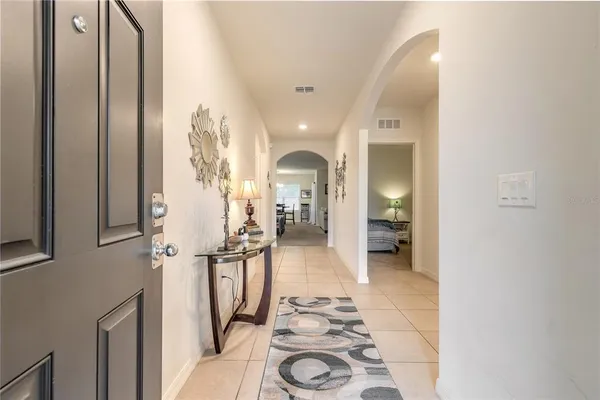 a view of a hallway with a livingroom and furniture