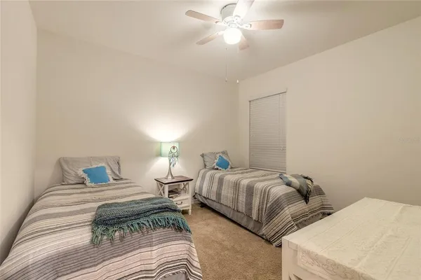 a bedroom with two beds and a chandelier