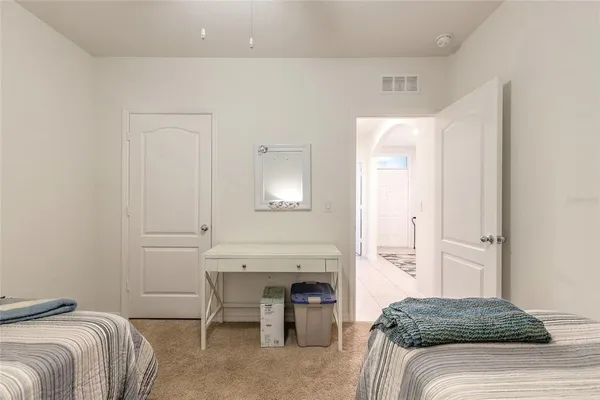 a bedroom with a bed and a table