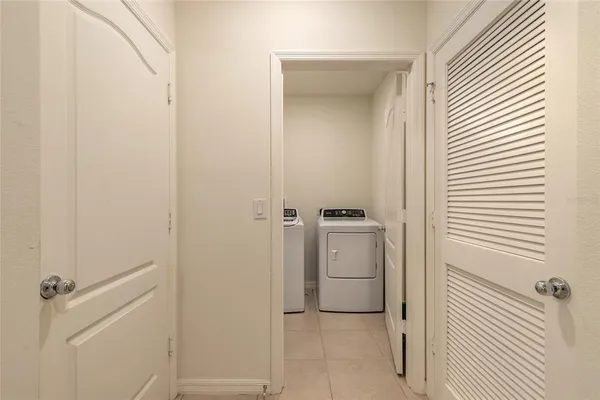 a utility room with cabinets washer and dryer