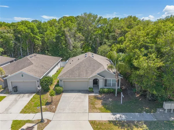 an aerial view of a house with a yard