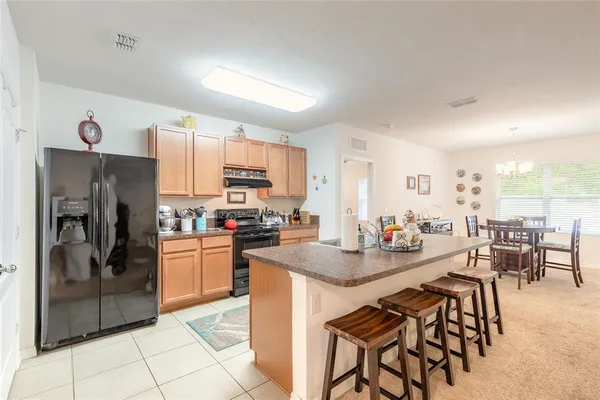 a kitchen with refrigerator and cabinets