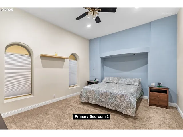 a bedroom with a bed and a painting on the wall