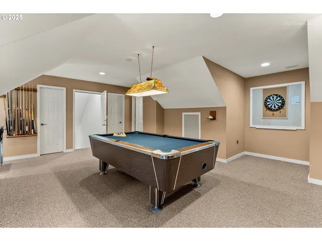 a room with pool table and windows