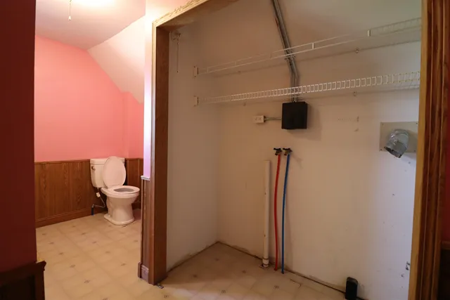 a bathroom with a toilet and a shower