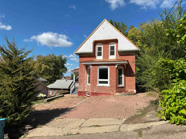 a view of a white house with a yard