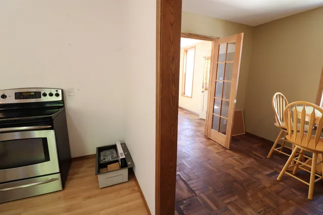 a view of a livingroom with wooden floor and furniture
