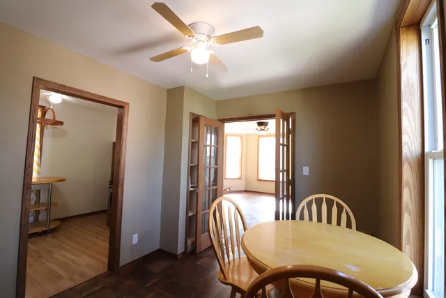 a view of a dining room with furniture and window