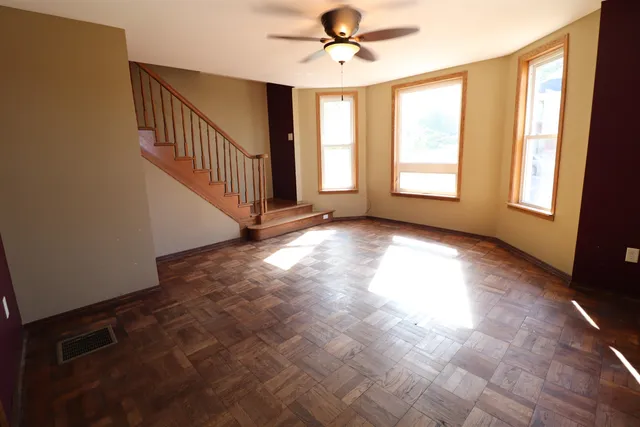 wooden floor in an empty room with a window